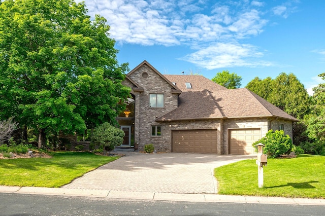 view of front of property with a front lawn and a garage