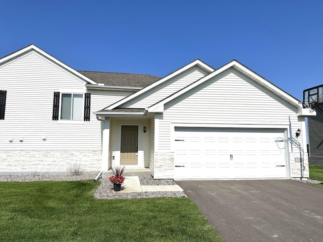 view of front of home with a front lawn and a garage