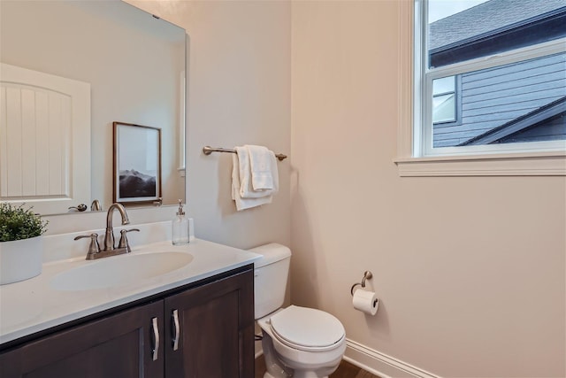 bathroom with toilet and vanity