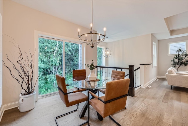 dining room with an inviting chandelier and light hardwood / wood-style floors