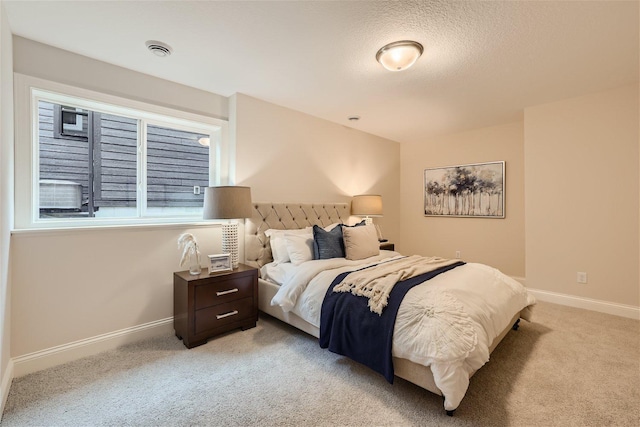 carpeted bedroom featuring a textured ceiling