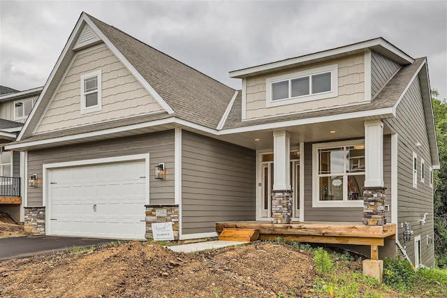 craftsman inspired home with a porch and a garage