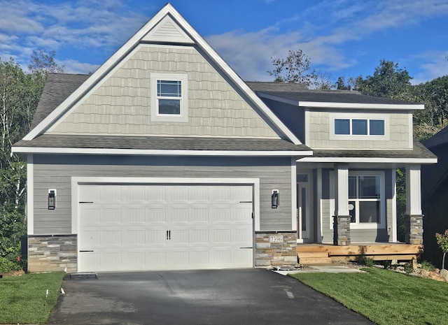 craftsman house with aphalt driveway, stone siding, a shingled roof, and a garage