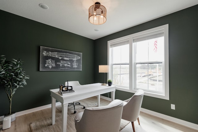 home office with wood finished floors and baseboards