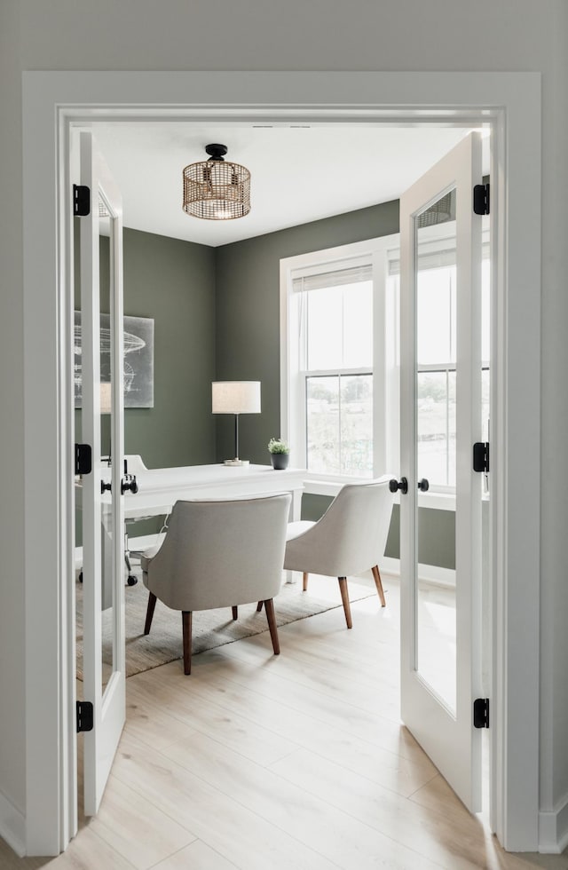 office space featuring light wood finished floors and french doors