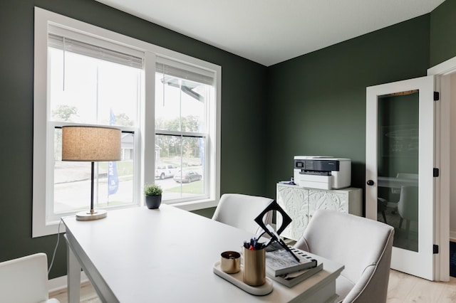 home office with light wood-style flooring