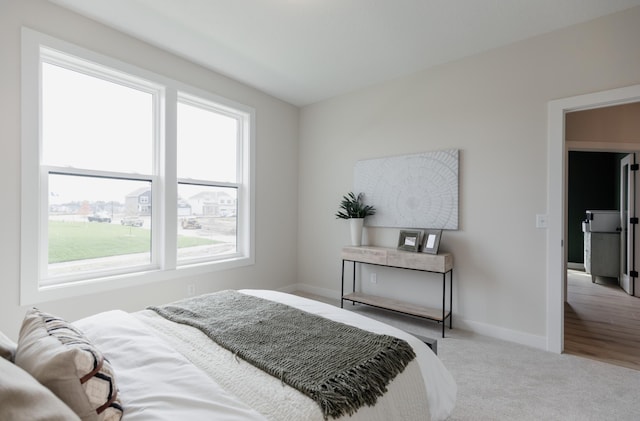 bedroom featuring carpet floors and baseboards