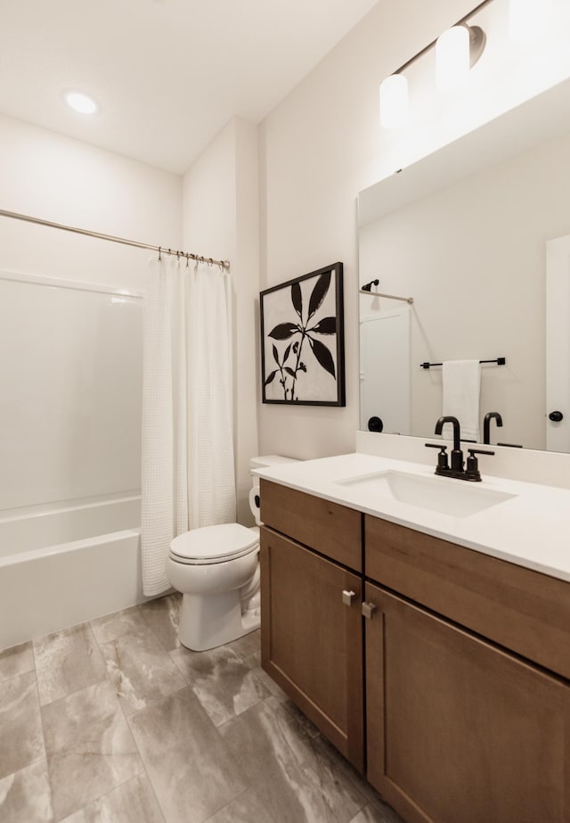 bathroom featuring vanity, shower / bath combo with shower curtain, and toilet