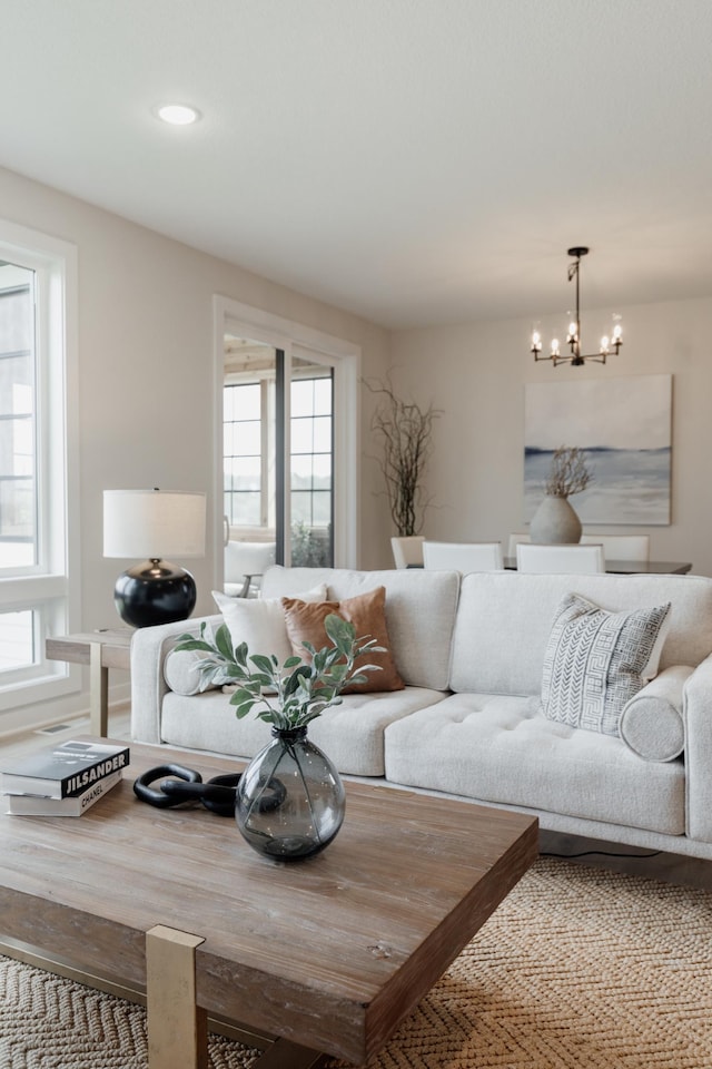 living area featuring recessed lighting, a healthy amount of sunlight, and a notable chandelier