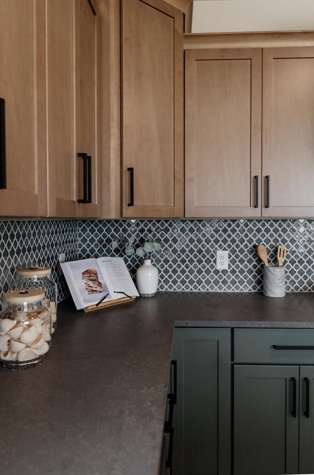 kitchen with tasteful backsplash and dark countertops