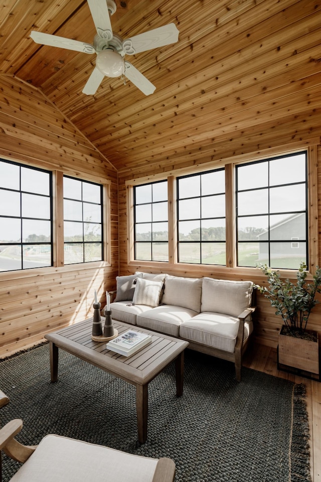 unfurnished sunroom with lofted ceiling, wooden ceiling, and ceiling fan