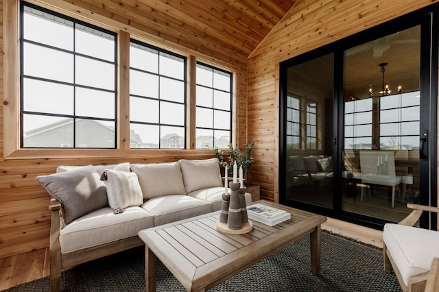 sunroom / solarium featuring wooden ceiling, vaulted ceiling, and an inviting chandelier