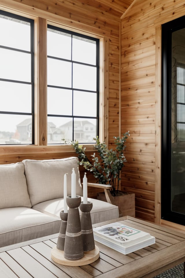 interior space with lofted ceiling and wooden walls