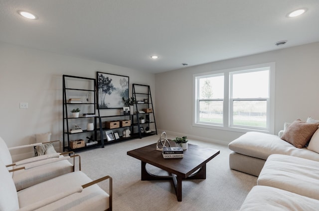 carpeted living room featuring baseboards and recessed lighting