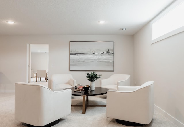 living area with carpet floors, baseboards, a textured ceiling, and recessed lighting