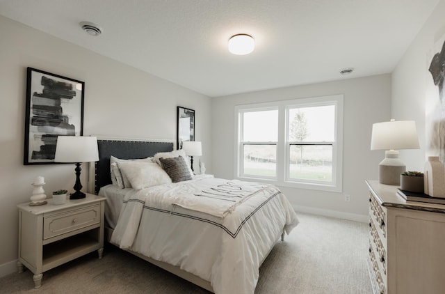 bedroom with light carpet, visible vents, and baseboards