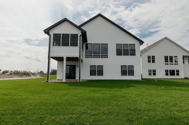 rear view of property with a lawn