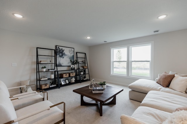 living area with light carpet and recessed lighting