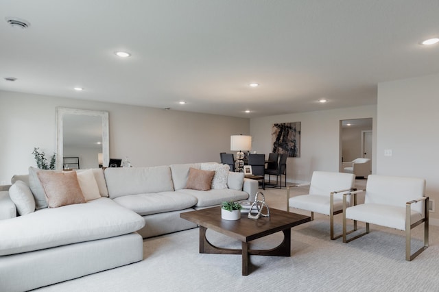 living room with recessed lighting and light colored carpet