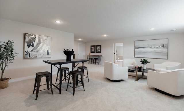 dining room featuring recessed lighting, light colored carpet, and baseboards