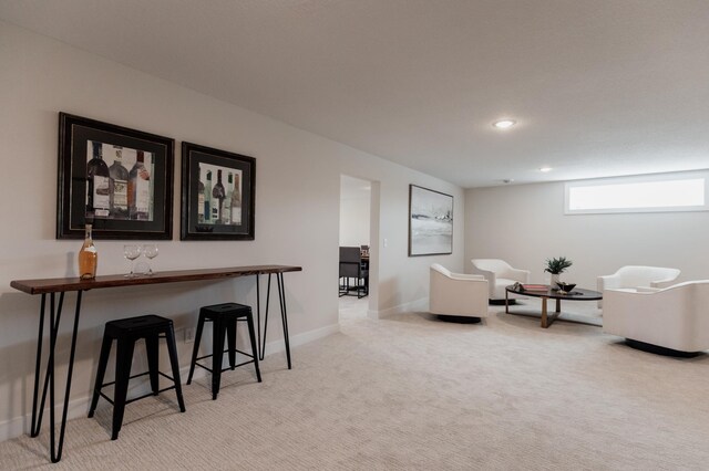 living area featuring baseboards, recessed lighting, and carpet