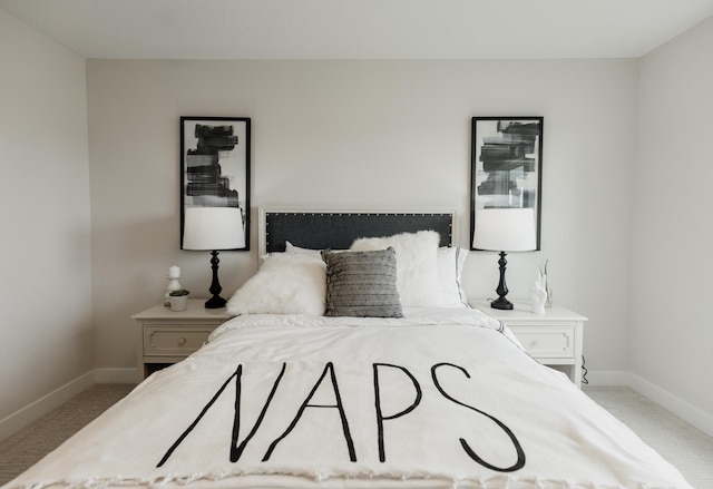 bedroom with baseboards and carpet