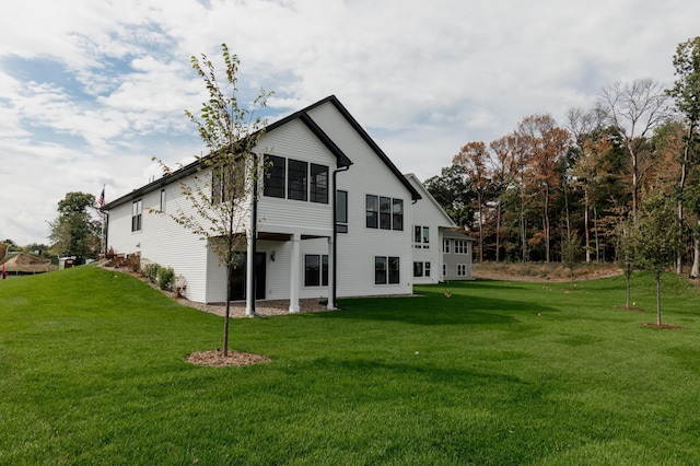 back of property featuring a yard