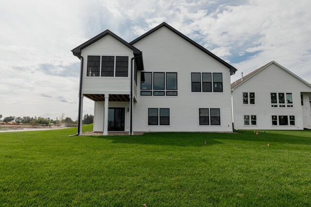 back of property featuring a yard