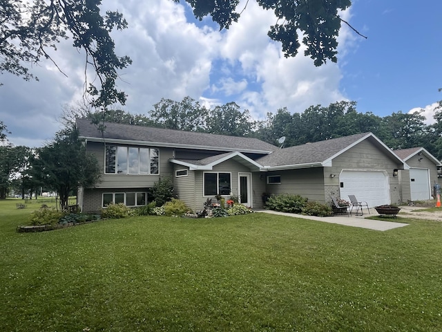 view of front of home with a garage, a patio area, and a front lawn