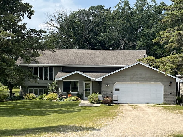 bi-level home with a front yard and a garage