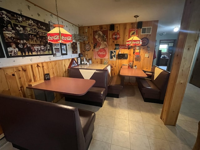 bar featuring wood walls, pendant lighting, and light tile patterned floors