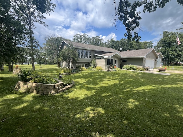 view of front of home with a garage and a front lawn