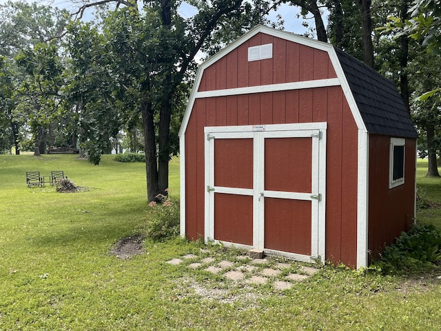 view of outbuilding featuring a yard