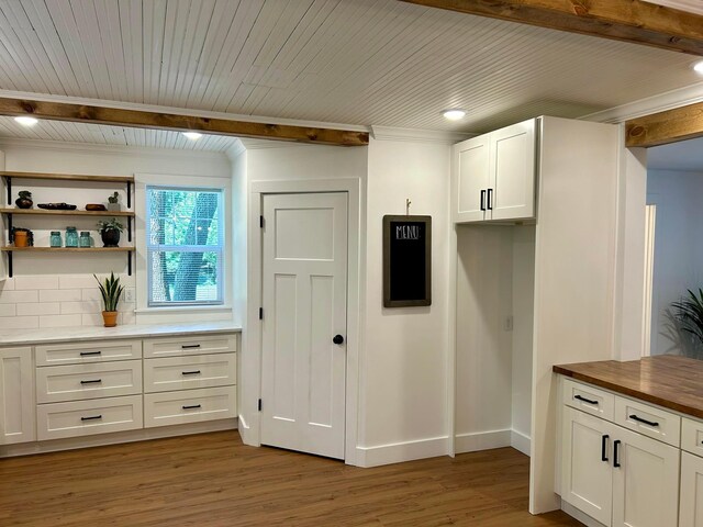 kitchen with white cabinets, beamed ceiling, wood ceiling, butcher block countertops, and dark wood-type flooring