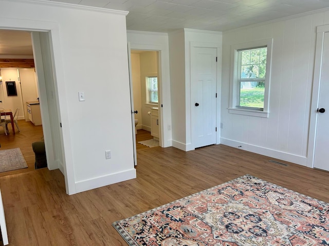 bedroom with ornamental molding and hardwood / wood-style flooring