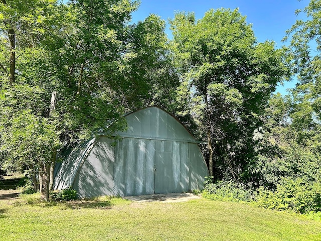 view of outbuilding with a lawn