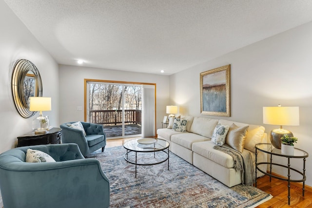 living room featuring hardwood / wood-style flooring and a textured ceiling