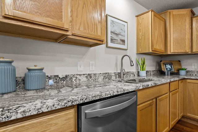 kitchen with dark hardwood / wood-style flooring, dishwasher, sink, and light stone countertops