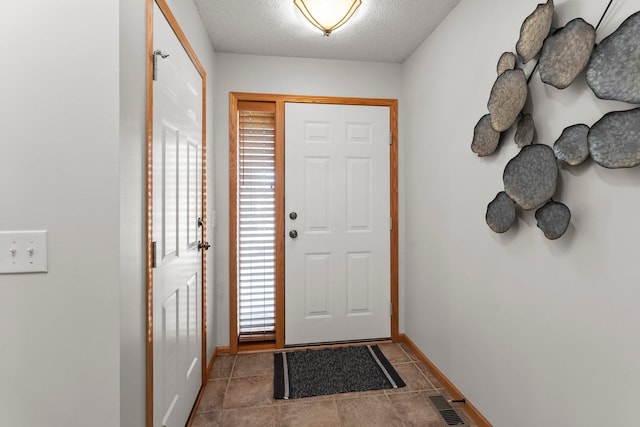 doorway with a textured ceiling