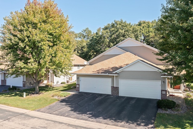 view of front of property featuring a garage and a front yard