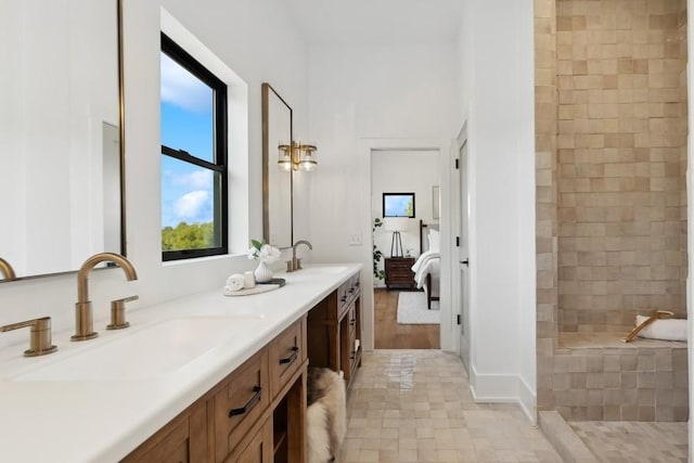 ensuite bathroom with double vanity, ensuite bath, a walk in shower, and a sink