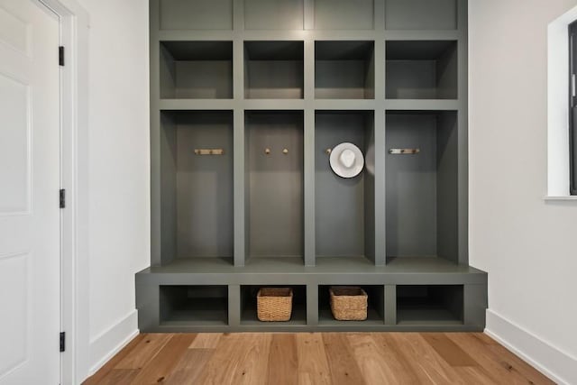 mudroom featuring baseboards and wood finished floors