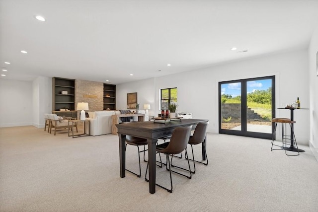 dining room featuring built in features, recessed lighting, light colored carpet, and baseboards