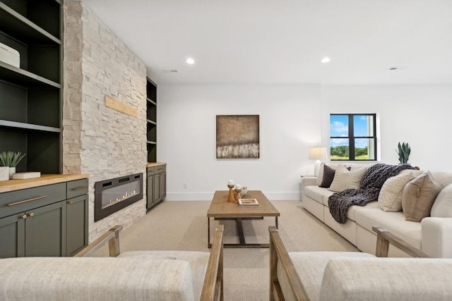 living room featuring built in shelves, recessed lighting, light colored carpet, a fireplace, and baseboards