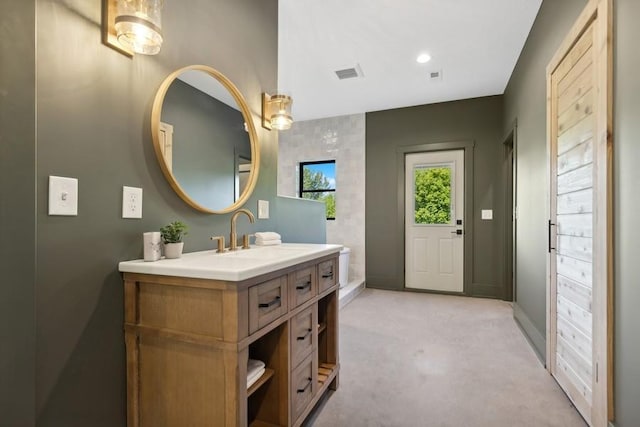 bathroom with baseboards, visible vents, and vanity