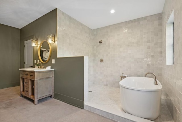 full bathroom featuring a soaking tub, vanity, a walk in shower, tile walls, and recessed lighting