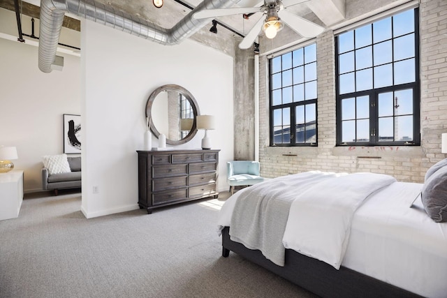 bedroom featuring brick wall, carpet floors, and ceiling fan