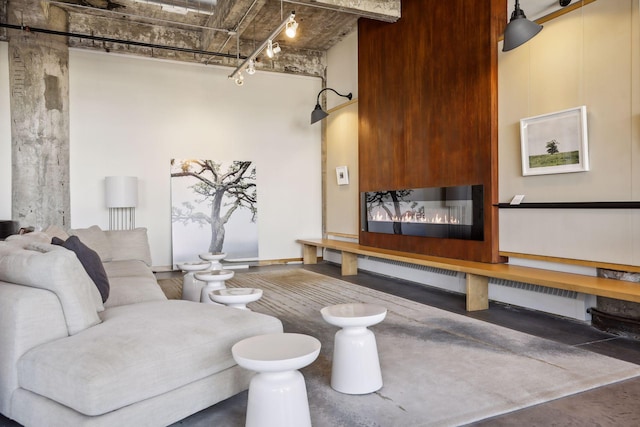 living room featuring track lighting and concrete floors