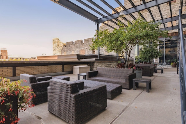 patio terrace at dusk with an outdoor living space and a pergola