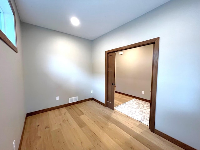 empty room with light hardwood / wood-style flooring